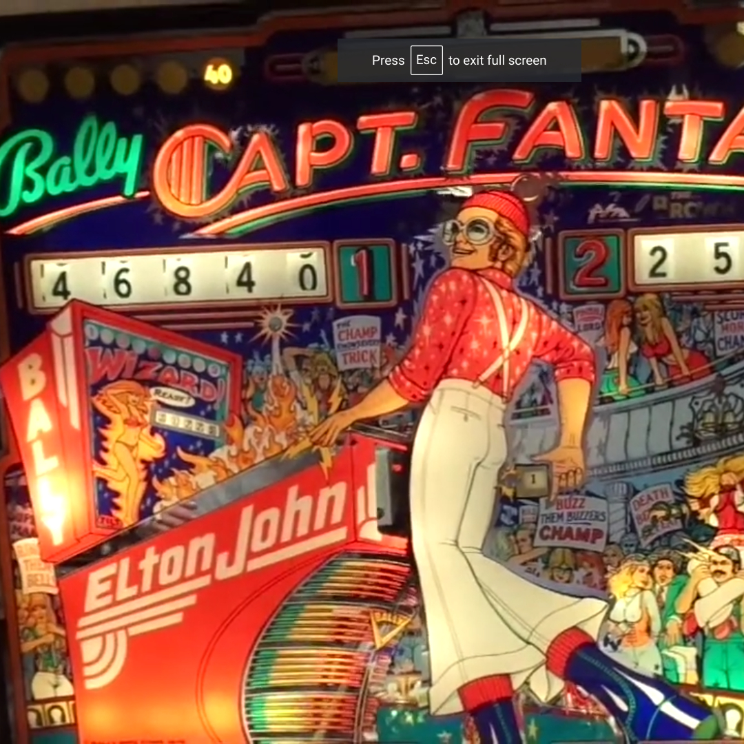 Screenshot of my Captain Fantastic Game in Play, featuring a 1970s-era Elton John in a red shirt and beret, and white bellbottoms with suspenders! Check out my YouTube Channel to see the video!