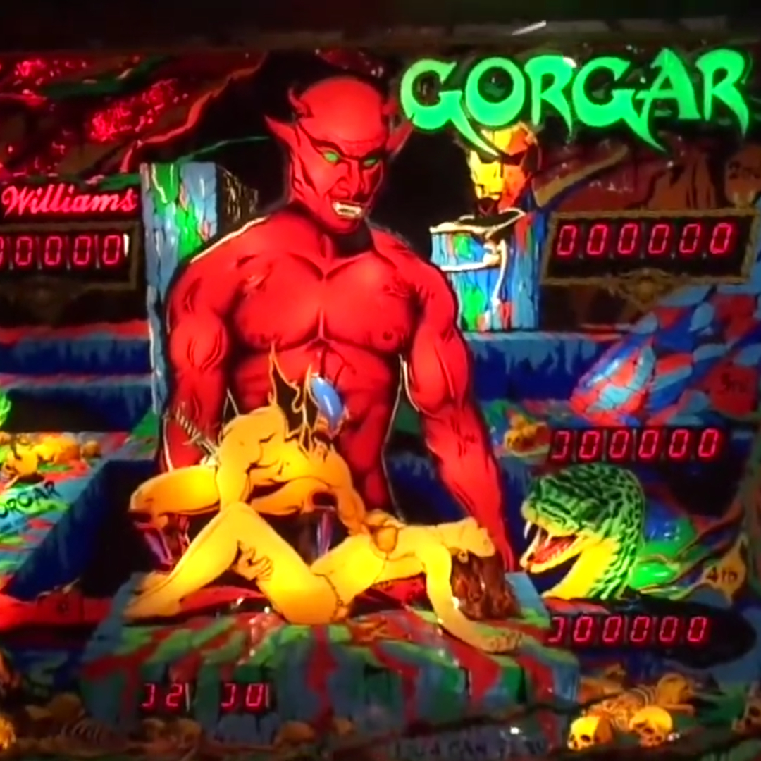A red muscular demon looms menacingly over a man who holds the lifeless body of a woman in an illustration for 1979 Gorgar by Williams, the first talking pinball machine.